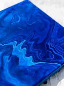 Harry Potter Acrylic Pour Canvas - This poured canvas is the perfect craft night project to DIY with friends! It's fun, messy, and no two canvases will be alike! You can leave them blank or use vinyl and your Silhouette or Cricut machine to dress them up a bit, like with a fun Harry Potter inspired quote or image...or really anything that you like. This craft project is colorful and easy, all you do is mix paint with water and pour!