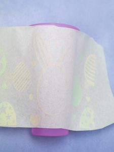 Putting the adhesive vinyl on the tumbler with paper transfer tape